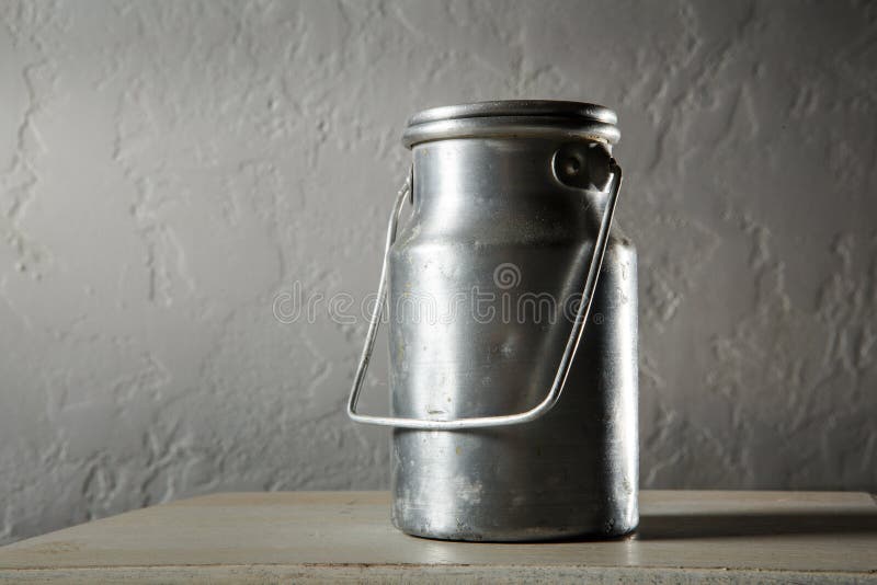 Old kind of aluminum bidon for milk storage stands on kitchen table. Traditional big metal pot stock images, royalty-free photos and pictures