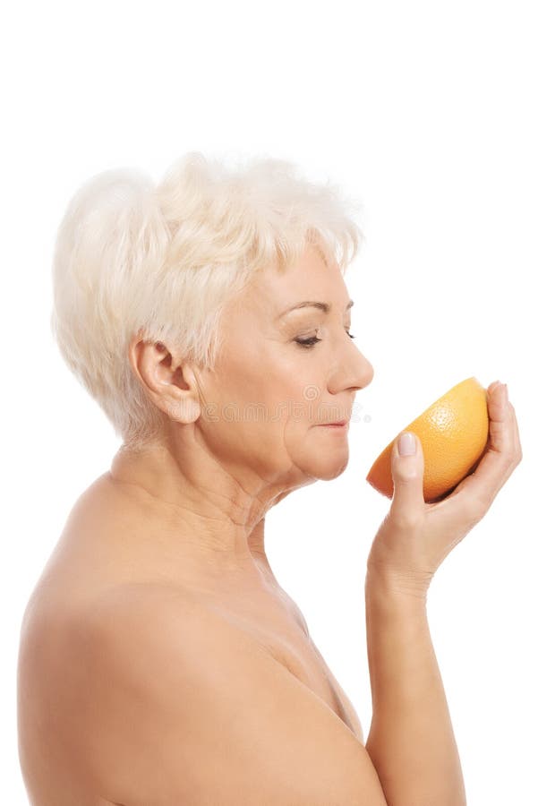 An Old Lady is Holding a Grapefruit. Spa Concept. Stock Photo Image