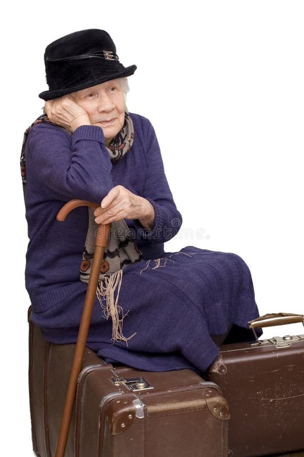 The old lady sits on a suitcase