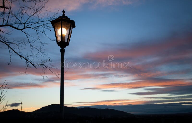 Old lamp post in sunset sky