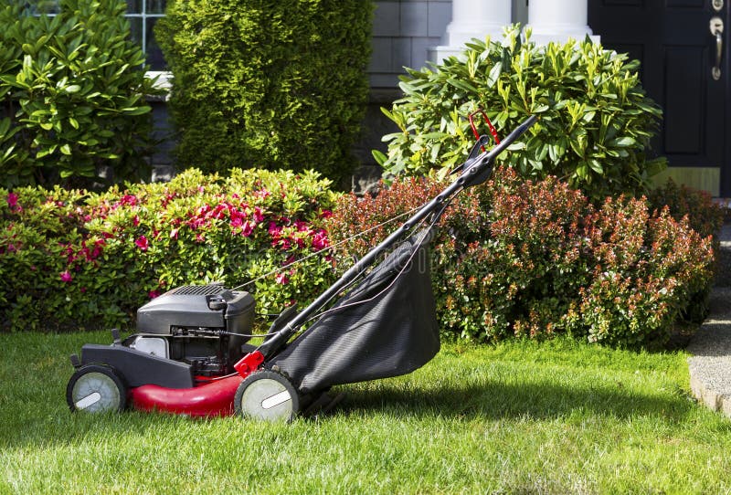 Old Lawnmower on Front Yard Ready for Work stock photos