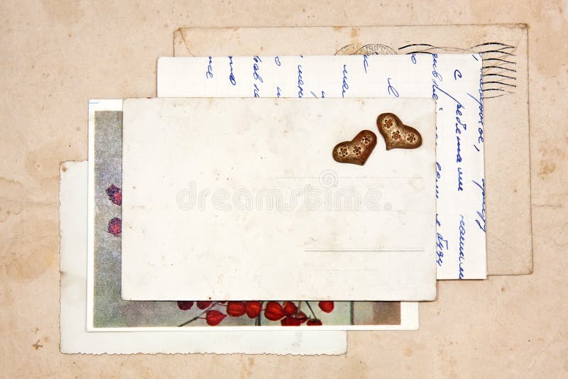 Old letters, empty post cards and two hearts, vintage background