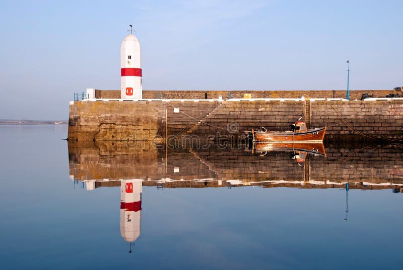 Old Lighouse and Boat with Sea Water Replection