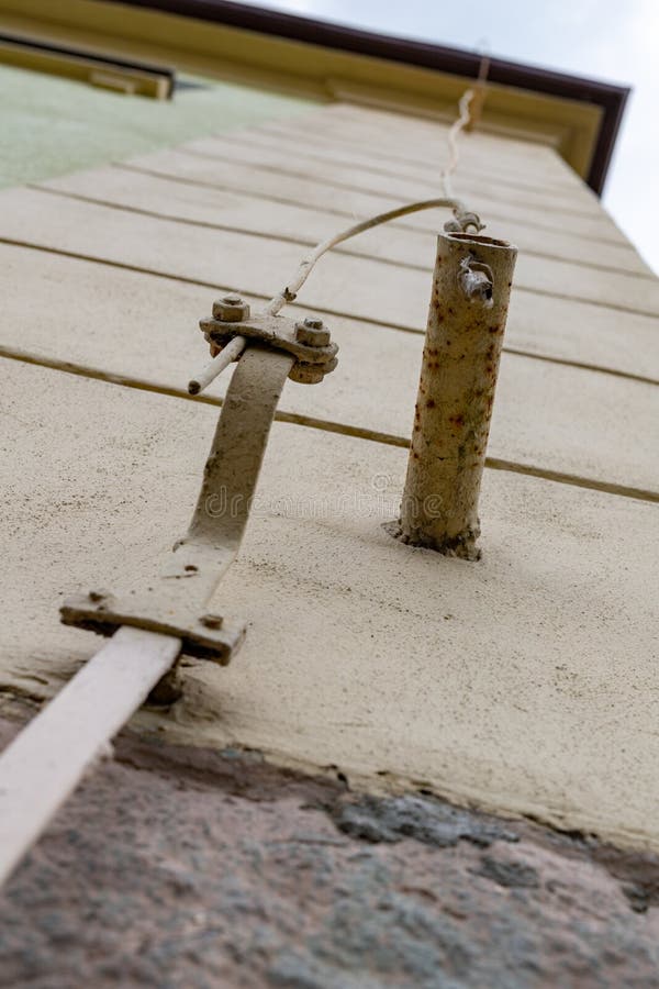 Old lightning protection in a detached house. Lightning protection cables stock photo