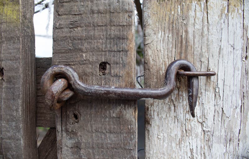 Old lock on the gate. lock on the door of an old rural home. real country style. close-up. focus on the castle stock photos Old lock on the gate. lock on the door of an old rural home. real country style. close-up. focus on the castle stock photos