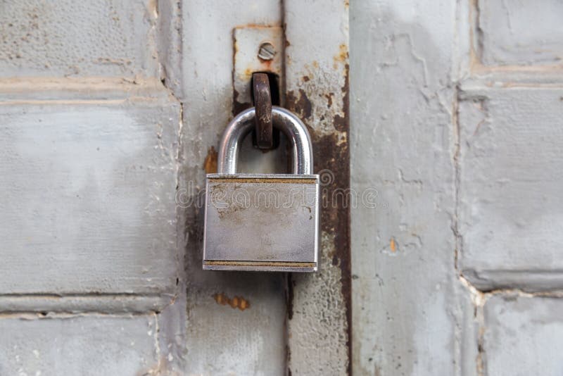 Old lock on wooden grungy painted door