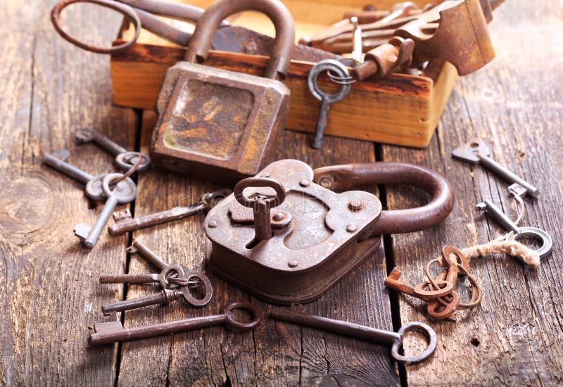 Old locks and keys on wooden table