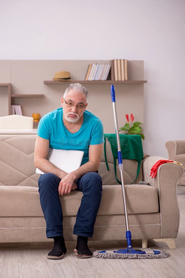 Old man cleaning the house stock image. Image of unhappy 238227809