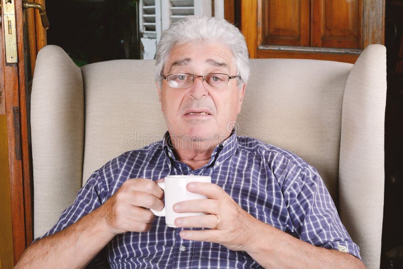 Old man drinking coffee. stock image