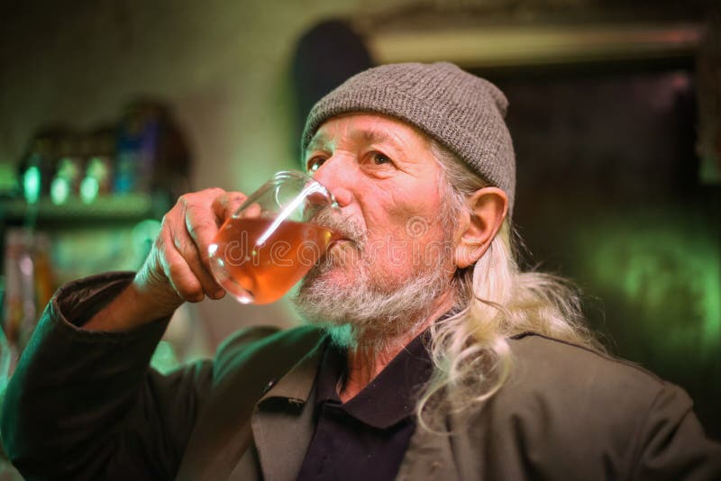 Old man drinking wine stock image. Image of indoors, indigent 91540747