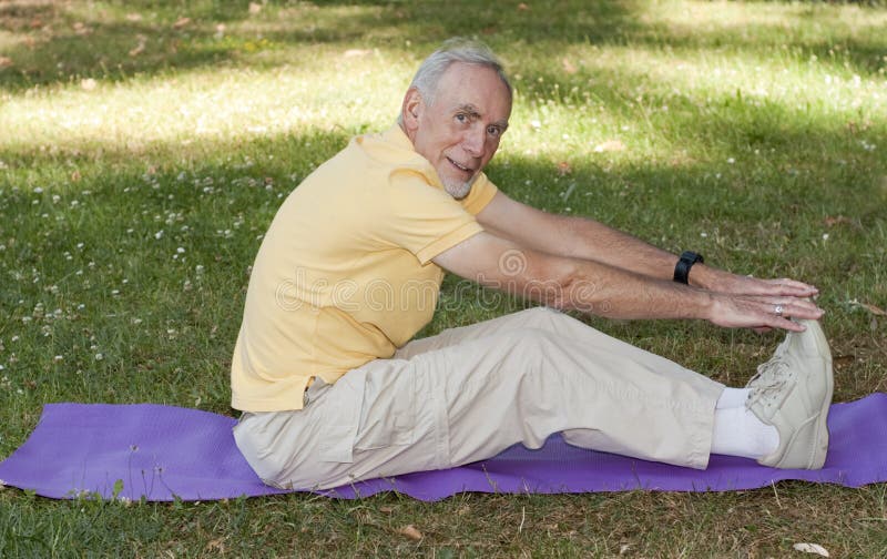 old-man-exercising-mat-park-12434865.jpg