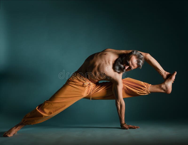 Old man with grey beard doing yoga, pilates, fitness training, stretching exercise, asana or balance workout on floor