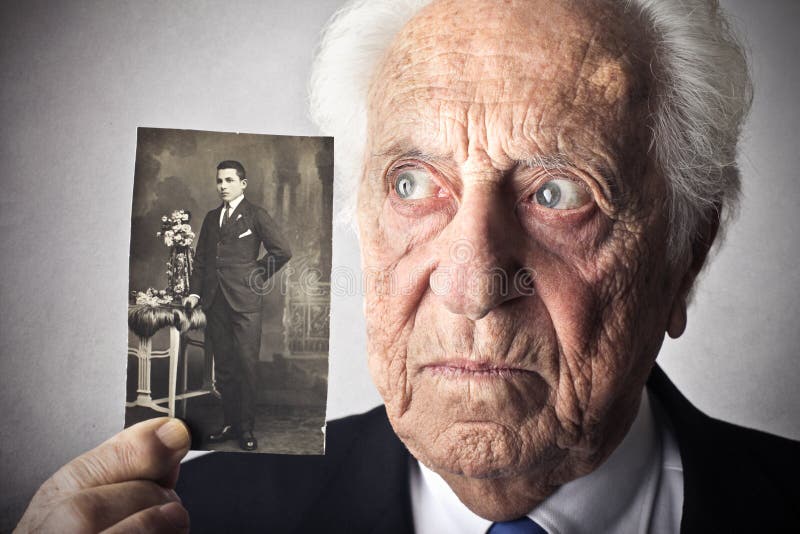 Old man holding his picture