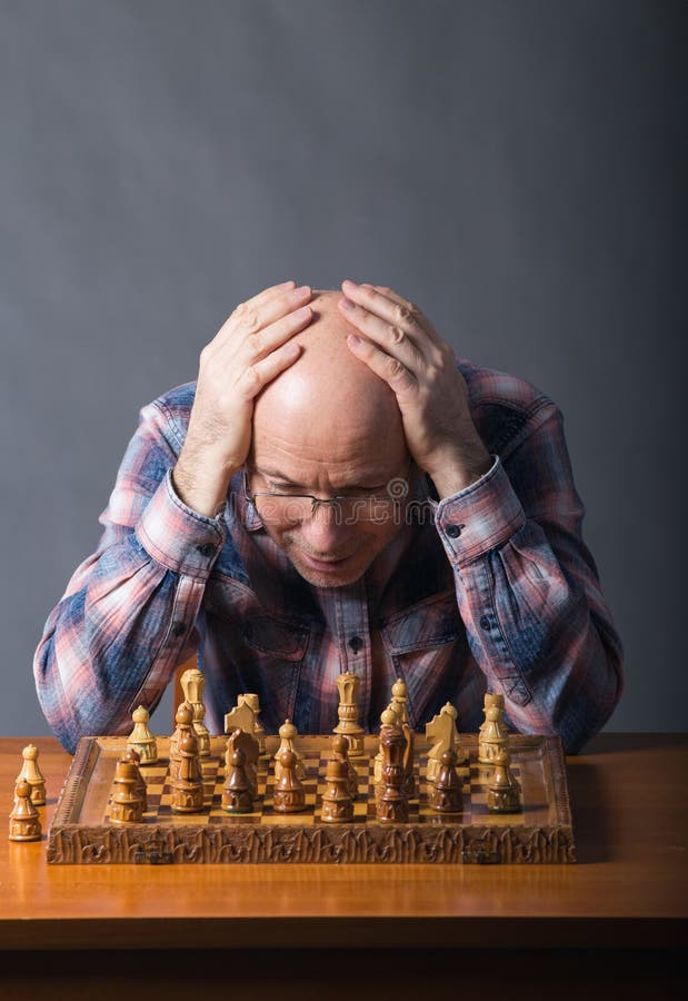 Senior man thinking about his next move in a game of chess Stock Photo by  dmytros9