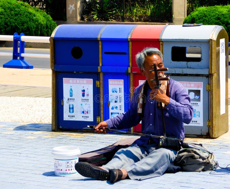 An old man playing erhu on qingdao street