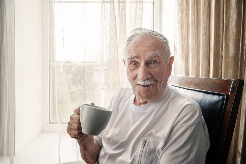 old-man-sitting-chair-smiling-window-cup-coffee-tea-portrait-close-up-copy-space-200772847.jpg