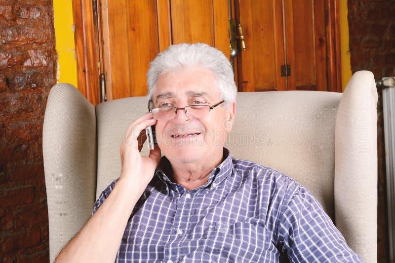 Old man talking on phone. royalty free stock photography