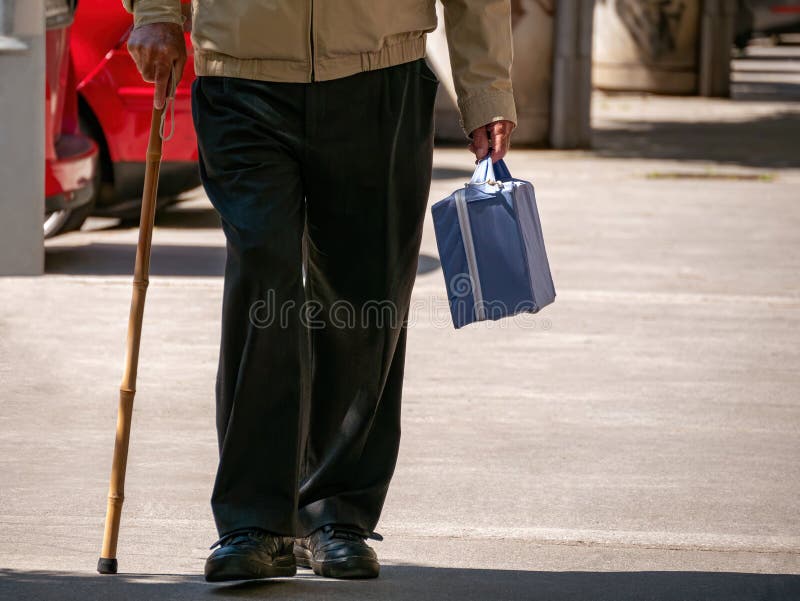 Old man walk with small suitcase and stick royalty free stock images Old man walk with small suitcase and stick royalty free stock images