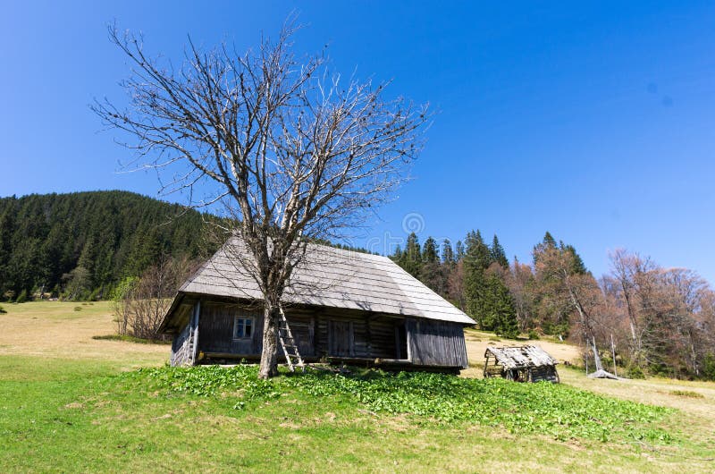 Old manor in a mountain landscape. Tree without leaves royalty free stock image Old manor in a mountain landscape. Tree without leaves royalty free stock image