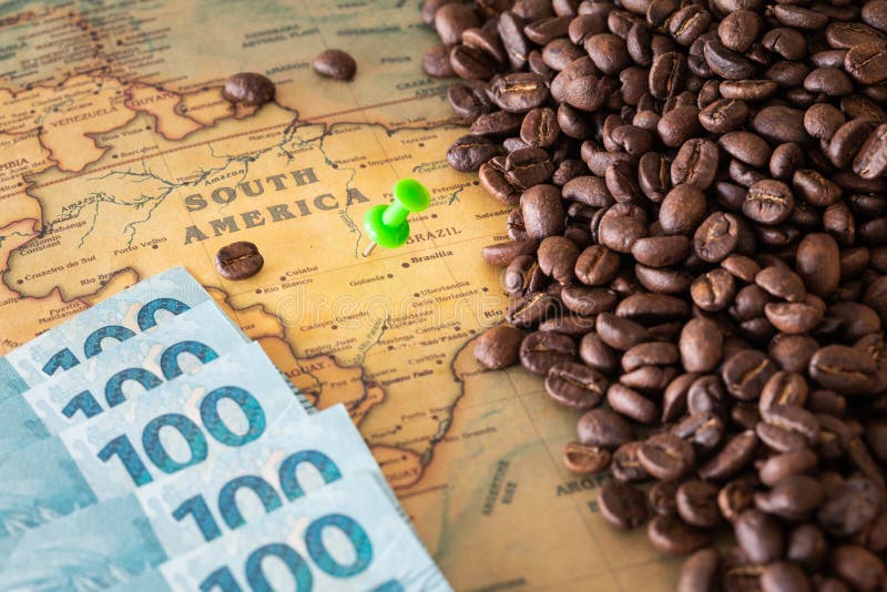 Old map of Brazil with scattered coffee beans and 100 reais banknotes, Concept of the largest coffee producer and exporter in the