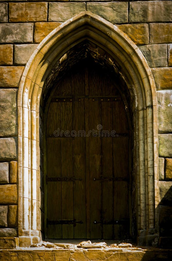An old medieval wooden door with a studded forged iron frame stock images An old medieval wooden door with a studded forged iron frame stock images