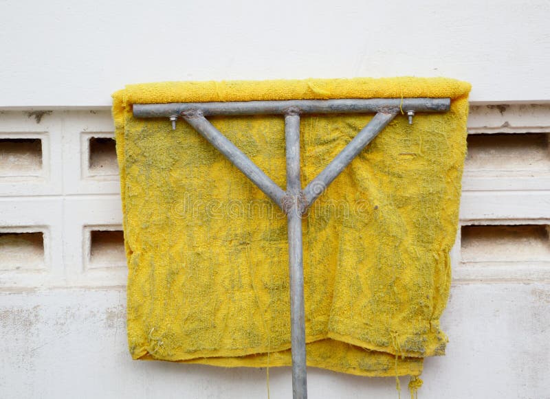 Old mop on cement wall stock photo. Image of container 260231004