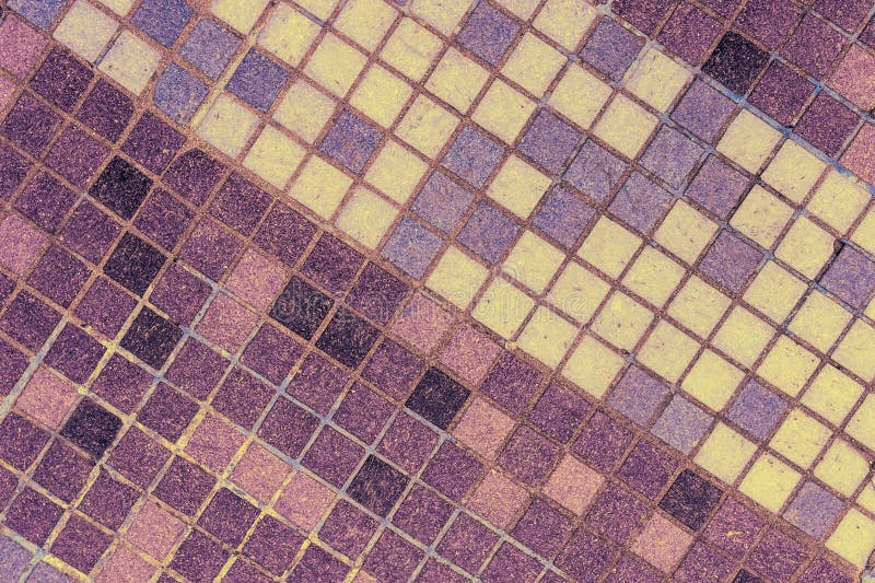 Old mosaic tiles of different shades lined diagonal