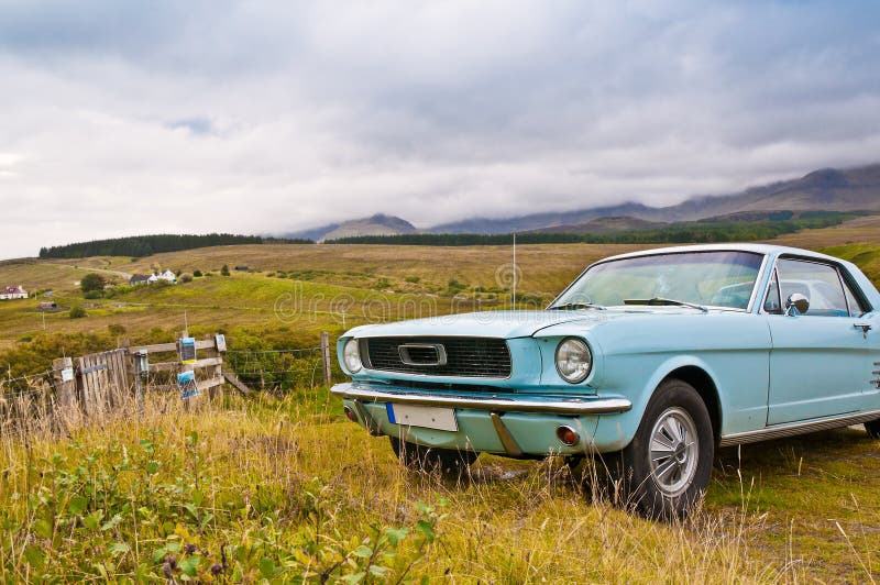 Old mustang car on countryside panorama