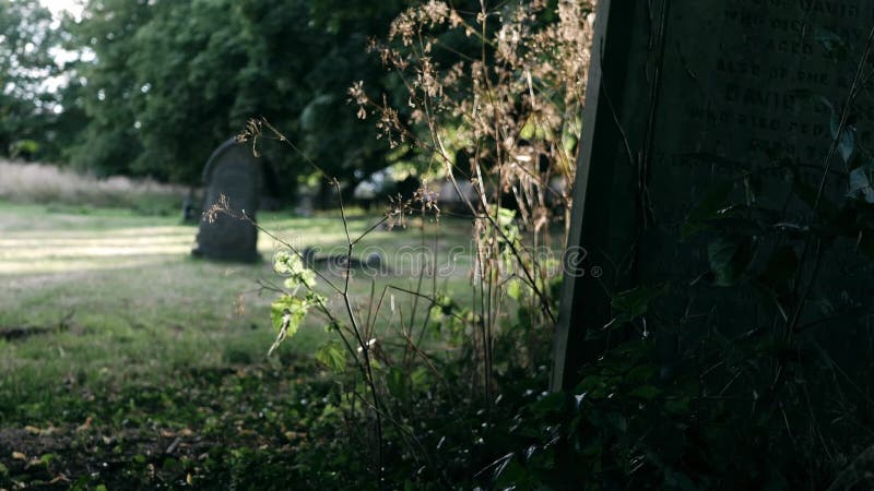 Old neglected headstone in church graveyard