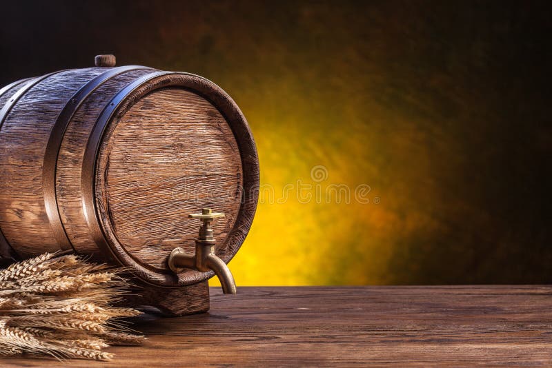 Old oak barrel on a wooden table. Behind blurred dark background.