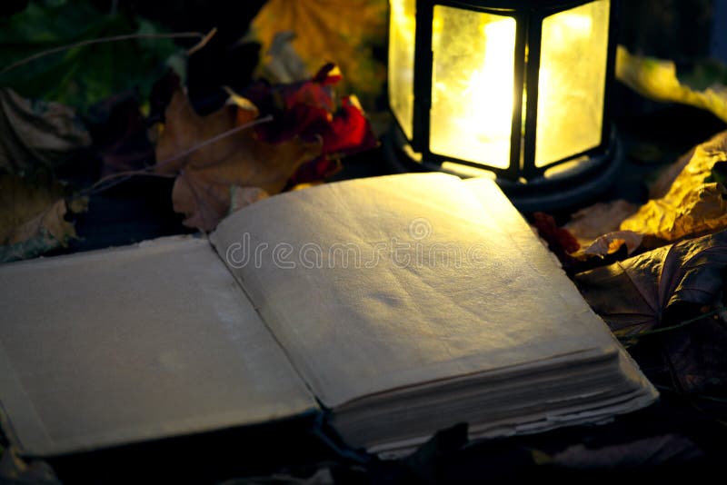 Old oil lamp and old open books