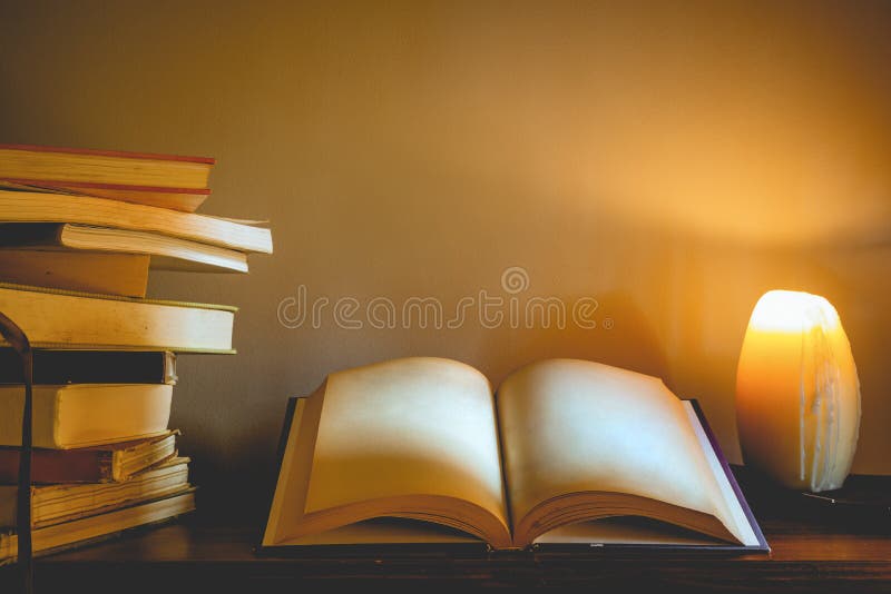 An old open book with blank pages on an old wooden table in a sp