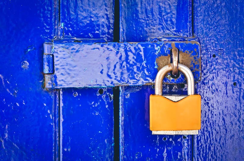 Old Orange Padlock on Wooden Blue Gate royalty free stock photos Old Orange Padlock on Wooden Blue Gate royalty free stock photos
