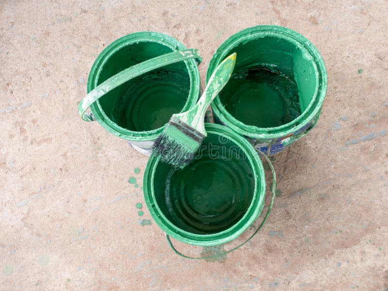 old-paint-brush-rest-top-green-paint-bucket-used-65827617.jpg