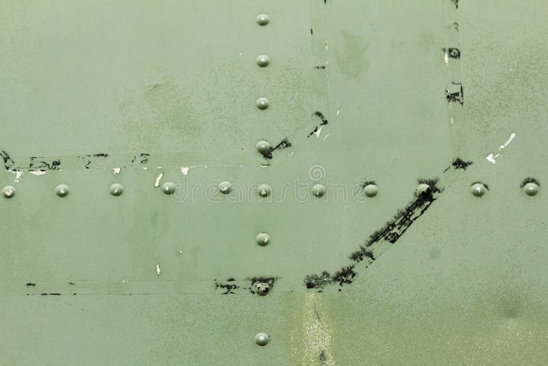 Old painted metal background detail of a military aircraft, surface corrosion. royalty free stock photos