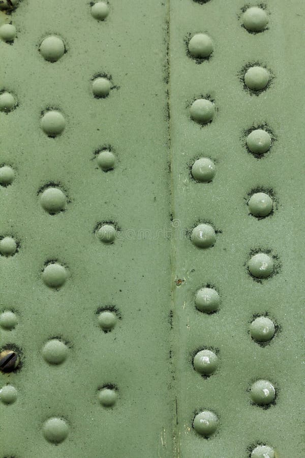 Old painted metal background detail of a military aircraft, surface corrosion. royalty free stock photo
