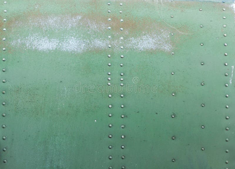 Old painted metal background detail of a military aircraft, surface corrosion. royalty free stock image
