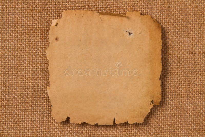 Old paper, empty yellow page on hessian canvas fabric royalty free stock photography