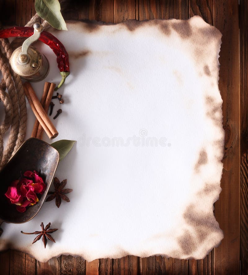 Old paper with spices on a wooden surface