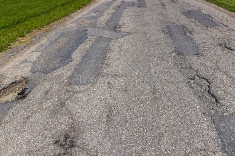 An Old Paved Road with a Lot of Holes and Damage Stock Image - Image of ...