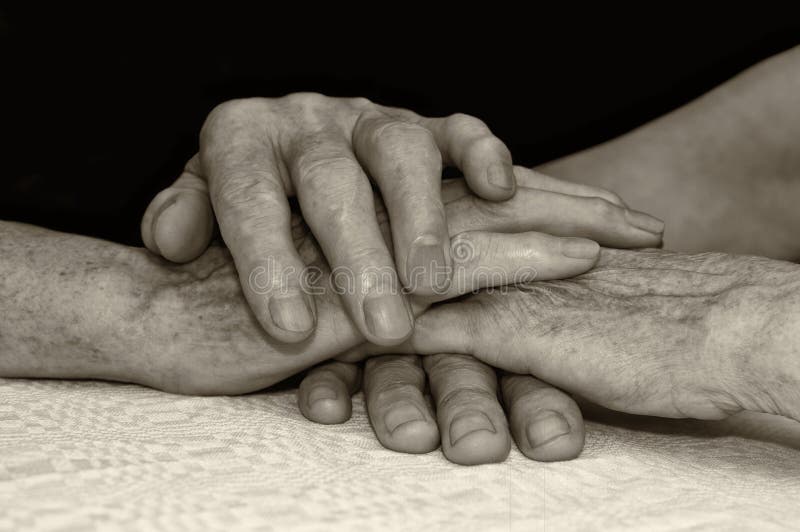 Old people hold each others hands. stock photo