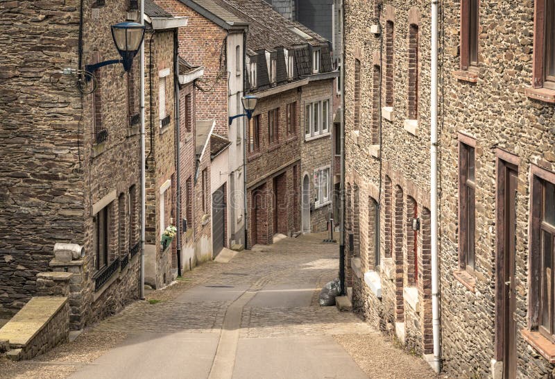 Beautiful curved street in the city of La Roche en Ardenne, a popular tourist destination in belgian Ardennes. Beautiful curved street in the city of La Roche en Ardenne, a popular tourist destination in belgian Ardennes