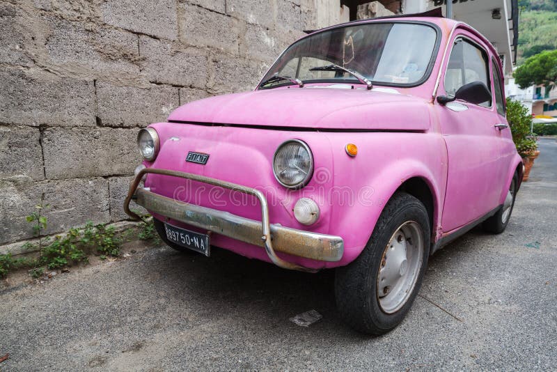 Old pink Fiat Nuova 500 city car, close up stock image Old pink Fiat Nuova 500 city car, close up stock image