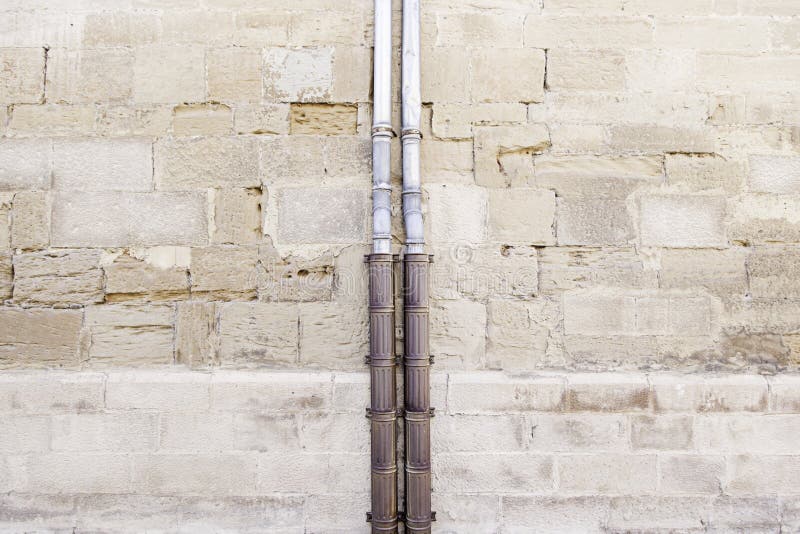 Old pipe in a stone wall royalty free stock images Old pipe in a stone wall royalty free stock images