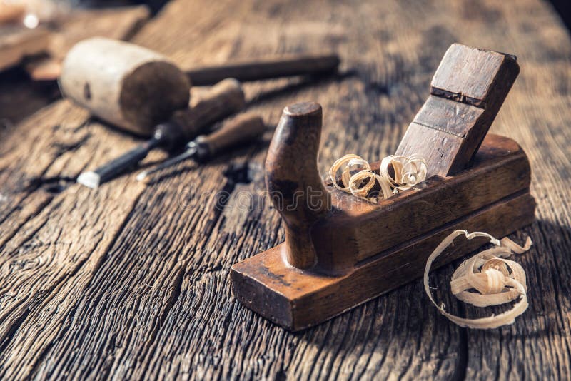 Old planer and other vintage carpenter tools in a carpentry workshop royalty free stock photo