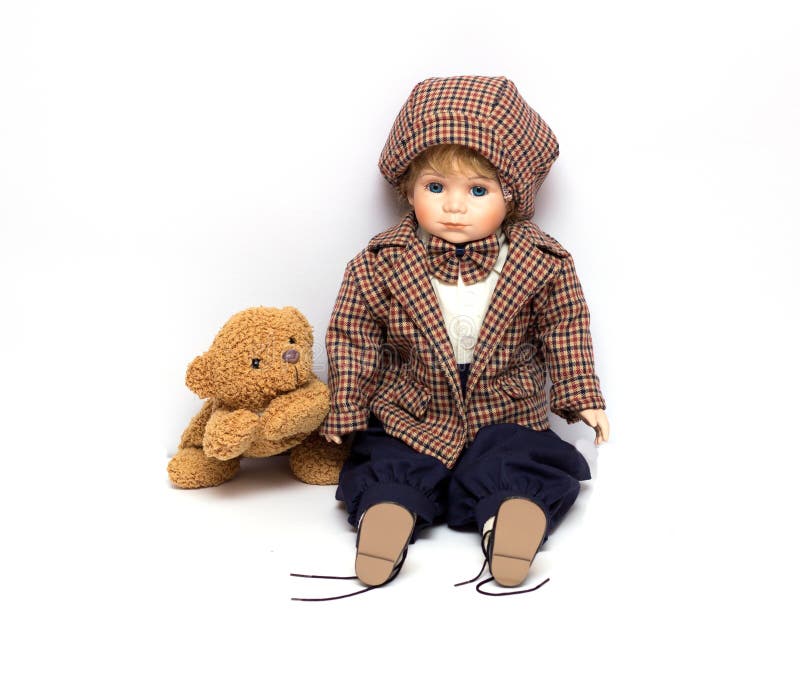 Old porcelain doll on White Background, ceramic dolls and a teddy bear. royalty free stock image Old porcelain doll on White Background, ceramic dolls and a teddy bear. royalty free stock image