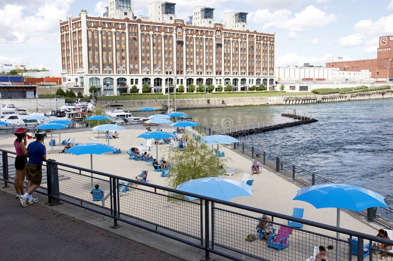 Located a short distance from the historical district, the Old Port of Montreal’s urban beach offers a vacation atmosphere with its fine sand, chairs, parasols and refreshing mist. Located at the foot of the Clock Tower, the beach offers a serene setting and spectacular view of the St. Lawrence Seaway and all Old Port attractions. Serene beach atmosphere stock images, royalty-free photos and pictures