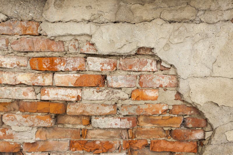 Old Red Brick Wall With Damaged Grey Plaster Background Stock Photo