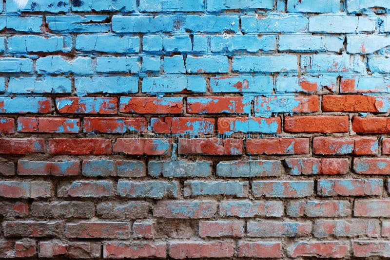 Old red brick wall half painted in bright blue color a lot of copyspace background.