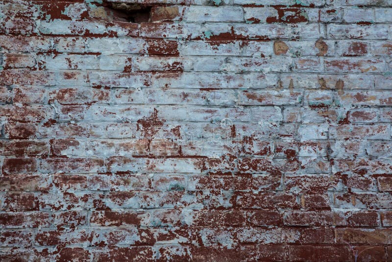 Old Brick Wall of Red Color with Scratches and White Spots. Stock Photo